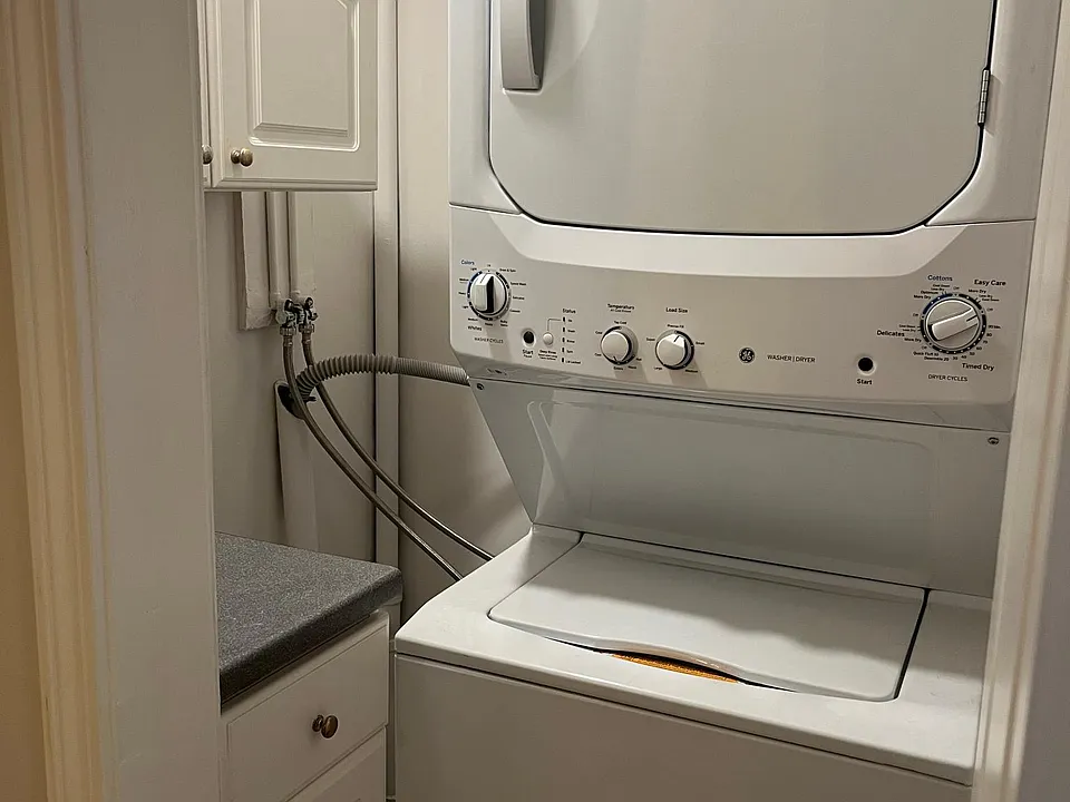 New Washer & Dryer with storage cabinets in hallway