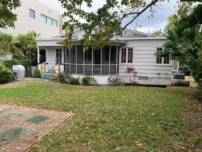 Porch and deck on L. Back yard is fenced. There is an alley in the back.