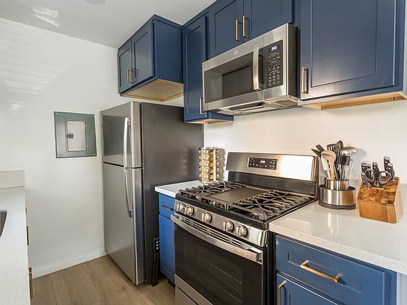 Refrigerator, microwave, stove and oven. Fully stocked with kitchen utensils.