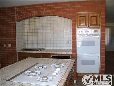 Built in BBQ on back wall with warming tray. Double oven