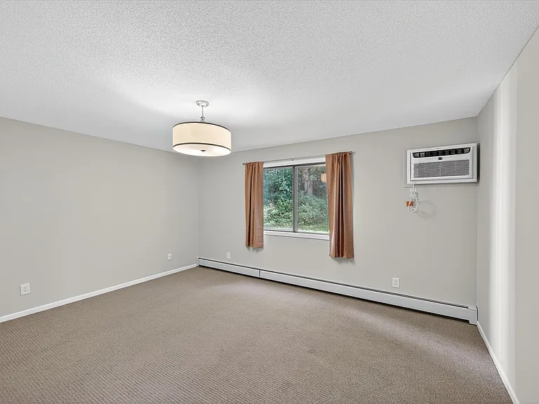 Spacious bedroom - Wall air conditioner has a remote and was recently replaced.