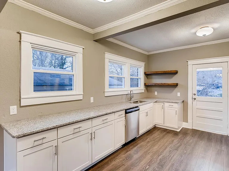 Updated kitchen with solid surface counters and stainless appliances.