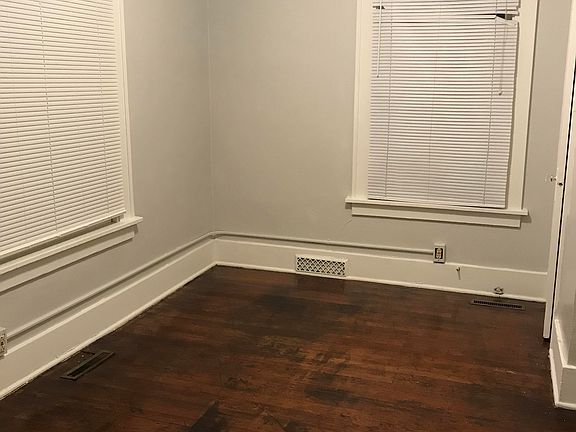 1st bedroom. Window on the left faces west (front of house), other window faces north. There is a half bath connected to the 1st bedroom. Has closet and built in wall storage. Hardwood floors in bedroom and bathroom. Dimensions: 12x9ft