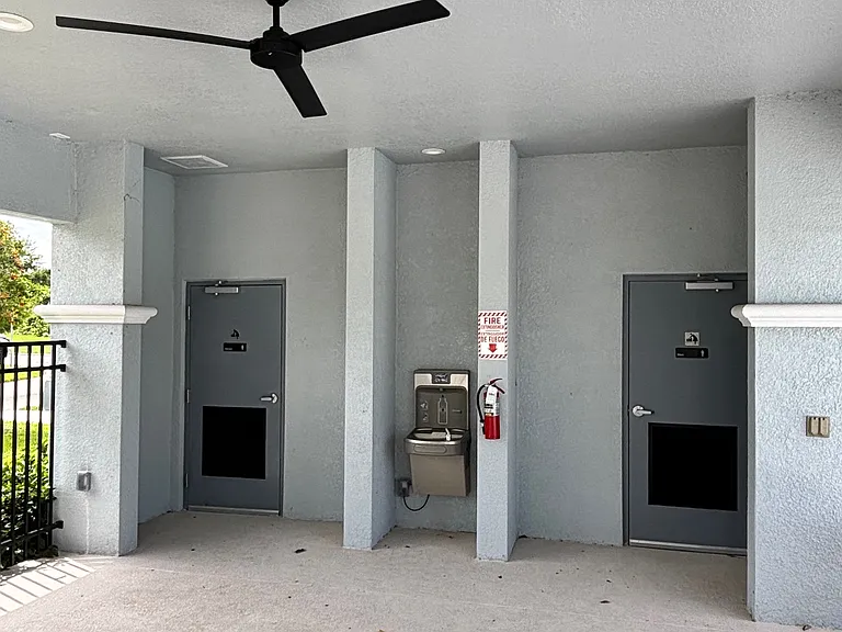 Comunity pool cabana with two restrooms.