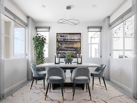 A modern and minimalist dining room with a rectangular table, gray chairs, and a large abstract artw
