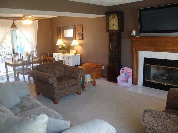 Spacious living and dining areas with gas log fireplace