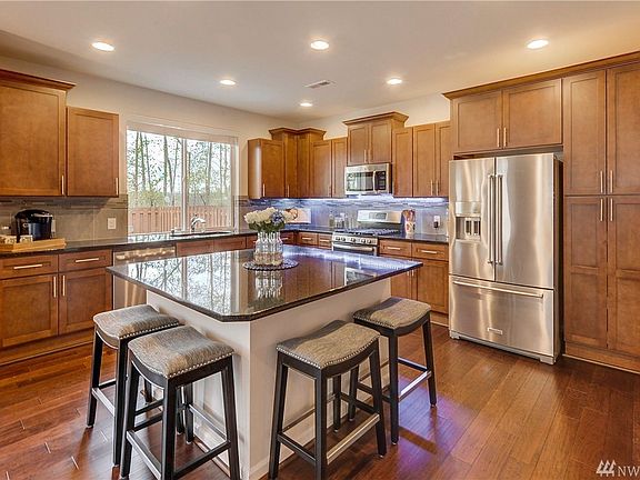Kitchen has slab granite counter tops and island. Lights under cabinets change colors! 