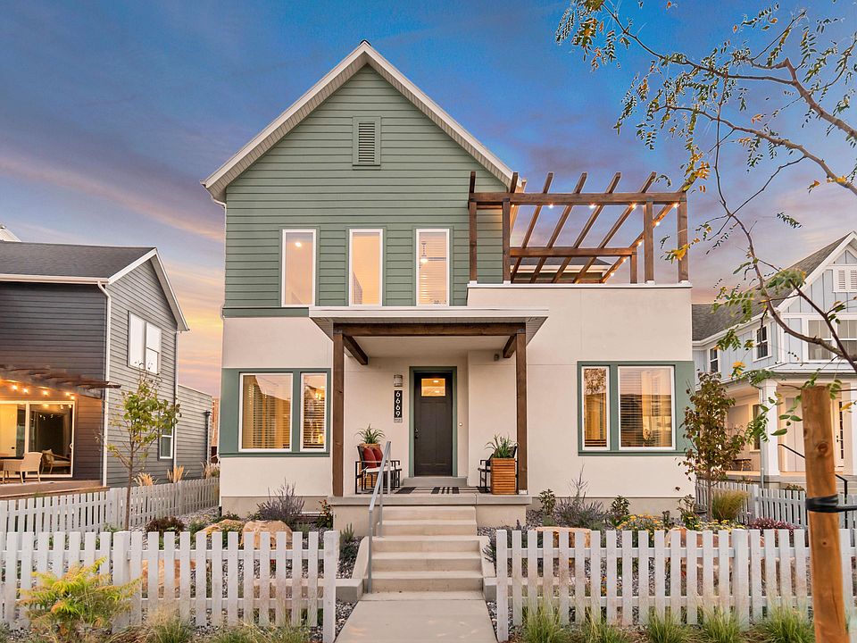 A modern two-story house from the Contempo Collection features a green and white exterior, large win