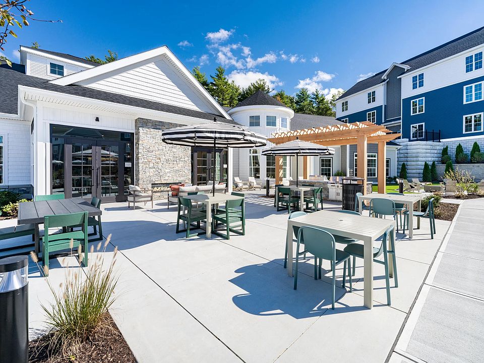 Enjoy the sunshine or dine in the shade_this inviting outdoor space features lounge seating, shaded tables, and a grill-ready pergola setup.