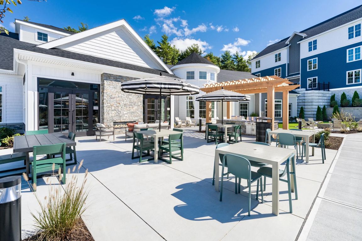 Enjoy the sunshine or dine in the shade_this inviting outdoor space features lounge seating, shaded tables, and a grill-ready pergola setup.