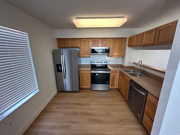 Kitchen with new LVP, stainless steel fridge, range/over, dishwasher, microwave / hood. New faucet.