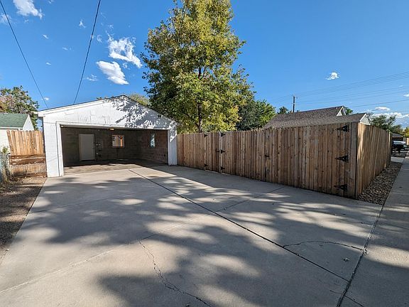 Two car garage with alley driveway and car-wide double gate into back yard