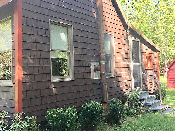 side of house with boat shed