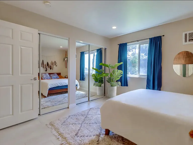 Make use of the spacious closet hidden behind the full-length mirrors in Bedroom 2