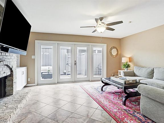 The windows and French doors overlook the patio and fill the room with light.