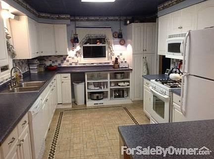 Updated Kitchen
						:
						Custom ceramic flooring, miles of counters perfect for baking or hosting parties