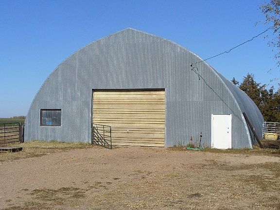 Roundtop Building with overhead door, skylights, and tackroom 