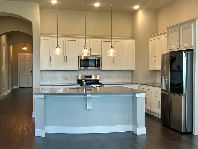 Large kitchen with lots of cabinets and counter space.