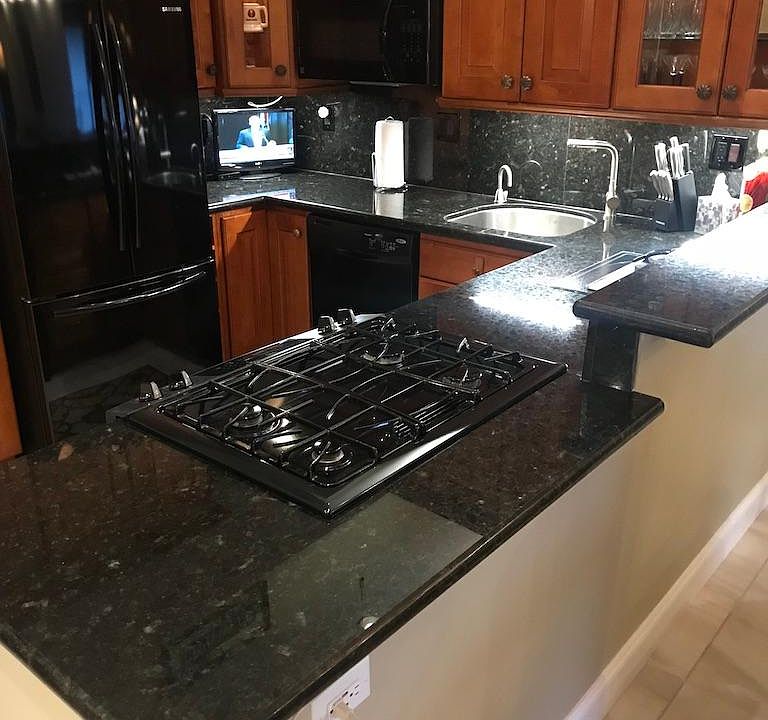 Spacious open kitchen with Black Granite countertops, Gas stove.