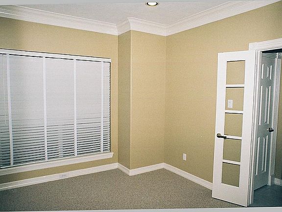 Inside, and adjoining the foyer, is your private study, newly carpeted, with double French doors for privacy.