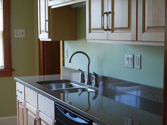 Kitchen with maple cabinets and quartz countertops