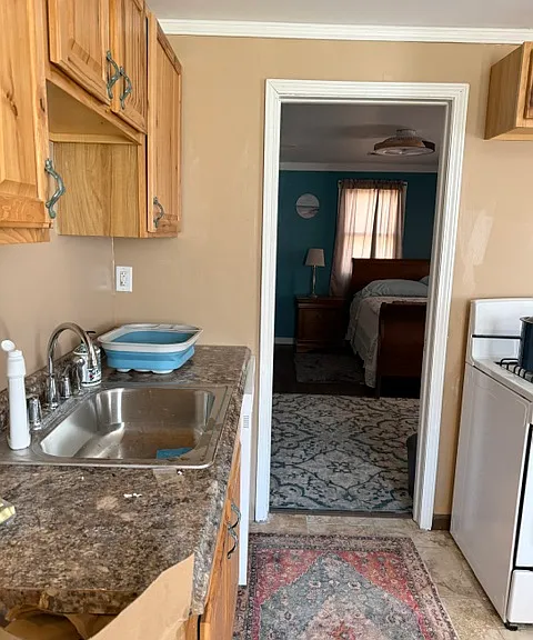 Kitchen with new appliances and rear door to back deck.