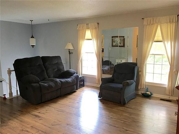 Bi-level home features an upstairs living room with BRAND NEW old hickory hardwood laminate.