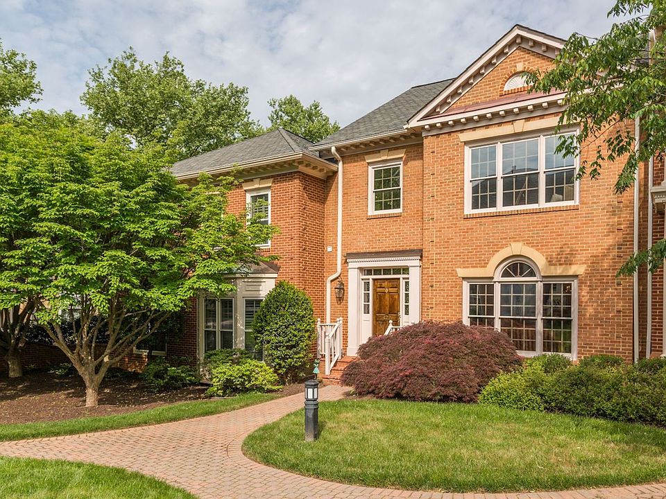 This stately colonial is tucked away from traffic on a tranquil courtyard