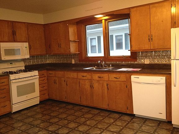 Large kitchen includes stove, refrigerator and dishwasher all stainless appliances.