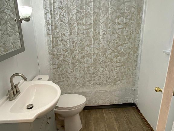 Bright and modern bath; love the fancy new faucet and freshened antique wall sconces!