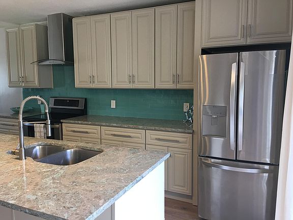 Stainless steel refrigerator with side by side and large drawer freezer.