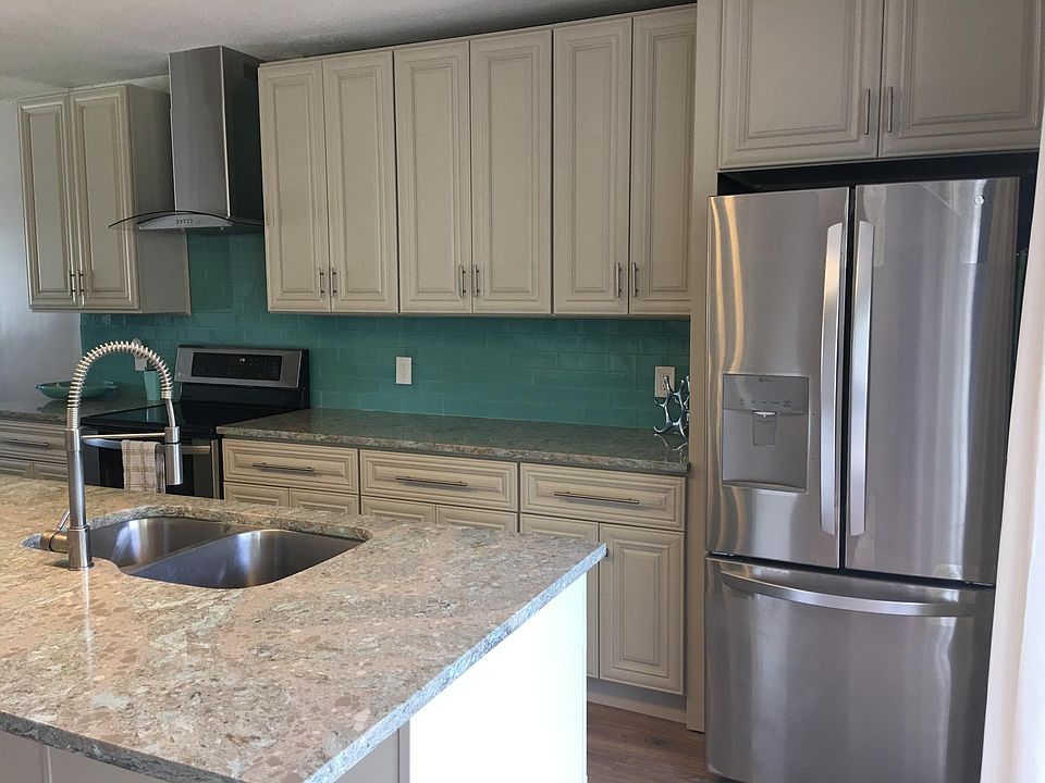 Stainless steel refrigerator with side by side and large drawer freezer.