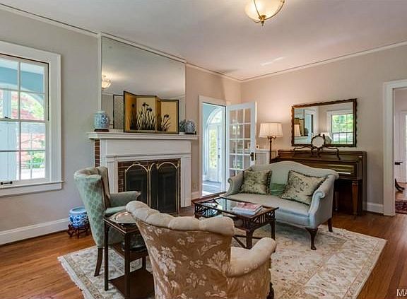 A traditional fireplace sets off the light filled and inviting l