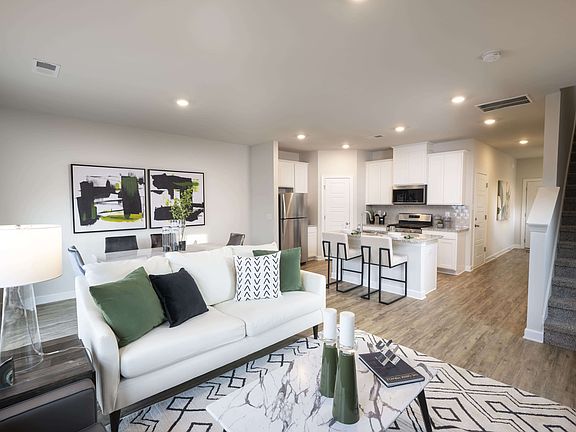The open-concept floorplan allows for easy entertaining. Photography from Foxcroft Townes.