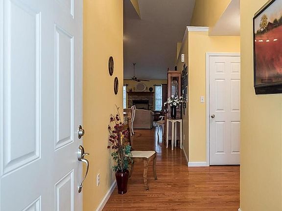 Wood foyer offers plenty of wall space for art work, furniture and more.