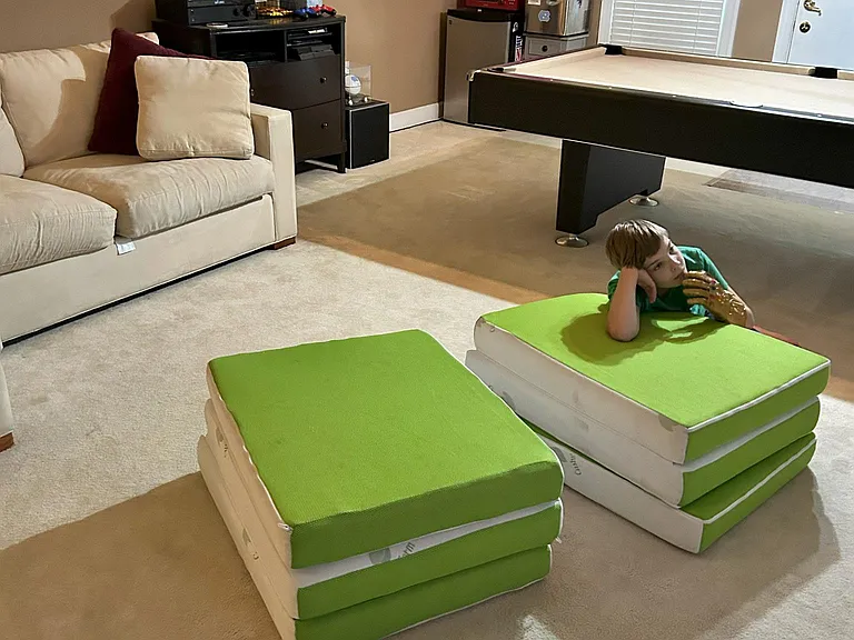 Pool table, mini fridge, 87 inch 4K TV with full in wall surround sound downstairs, as well as full bath. 2 Single foam mattresses pictured, can be stored in closet.