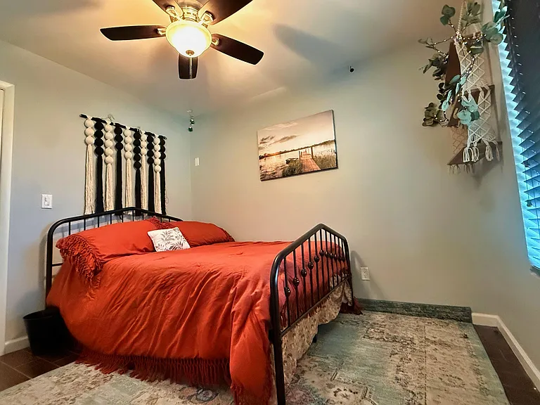 Queen-size bed and fiber-artwork.