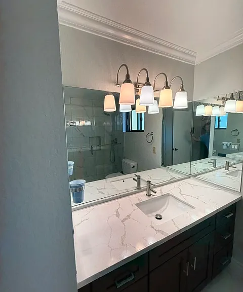 Brand-new bathroom (never been used). The only existing items are the mirror, light fixture, and toilet.