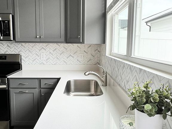 Gorgeous kitchen with lots of natural light. Quartz countertops, all new SS appliances