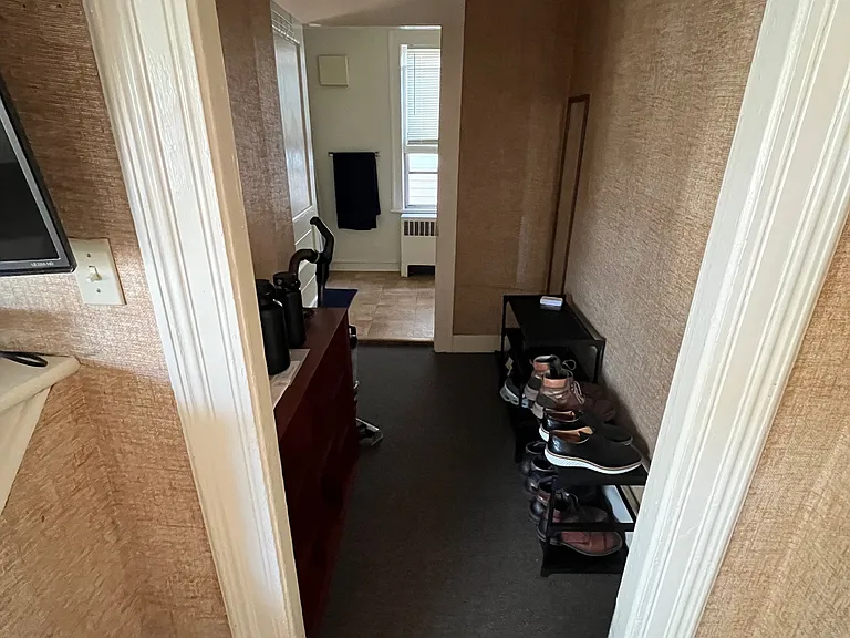 Hallway leading from entrance to living room (behind photo)