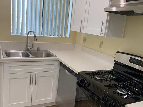 Stainless steel appliances, including a full-sized dishwasher.