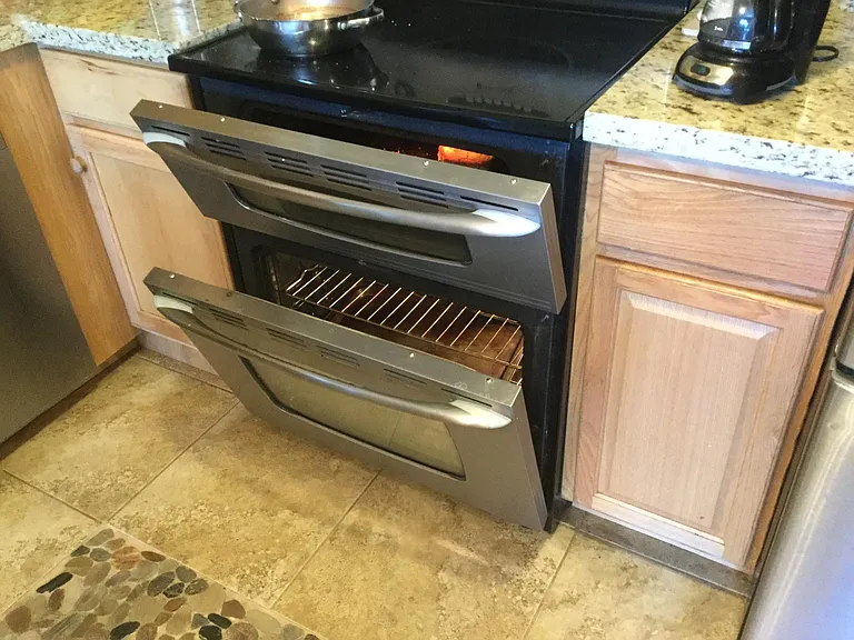 Stove with double oven, one is for pizza.
