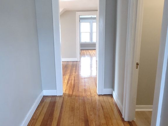 The apartment has plenty of natural lighting. This is the walkway entrance the door on the right is the bathroom. Straight ahead is the living room.