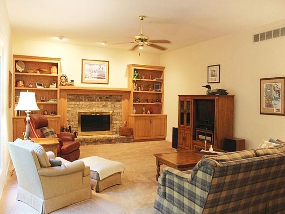 Comfortable and welcoming, the main floor family room will be one of your favorite hang-outs. The fireplace is wood burning with a gas starter and there are french doors looking out to the private wooded yard.