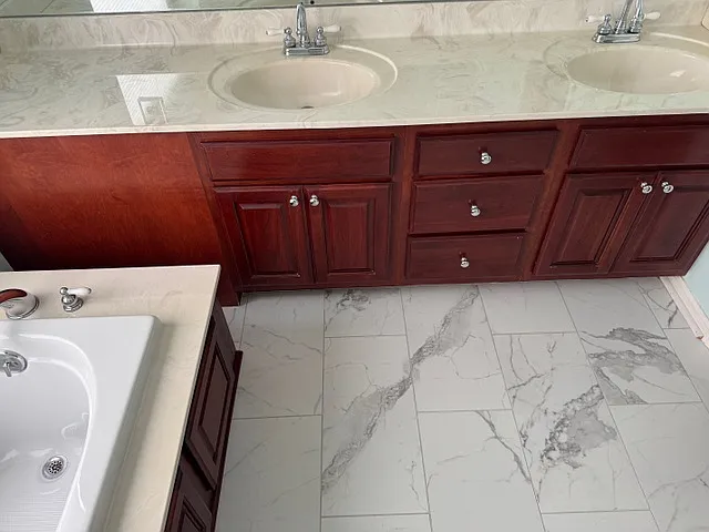 MBR Bathroom with double sink and tub.