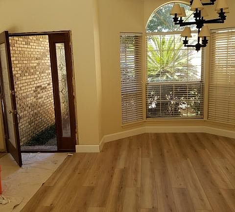 Front entry door on left (door and moulding have not been replaced at time of the picture. Dining room area to the right.