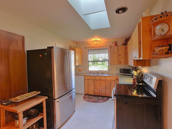 Updated appliances and window overlooking wisteria covered trellis. The pantry and laundry room is t