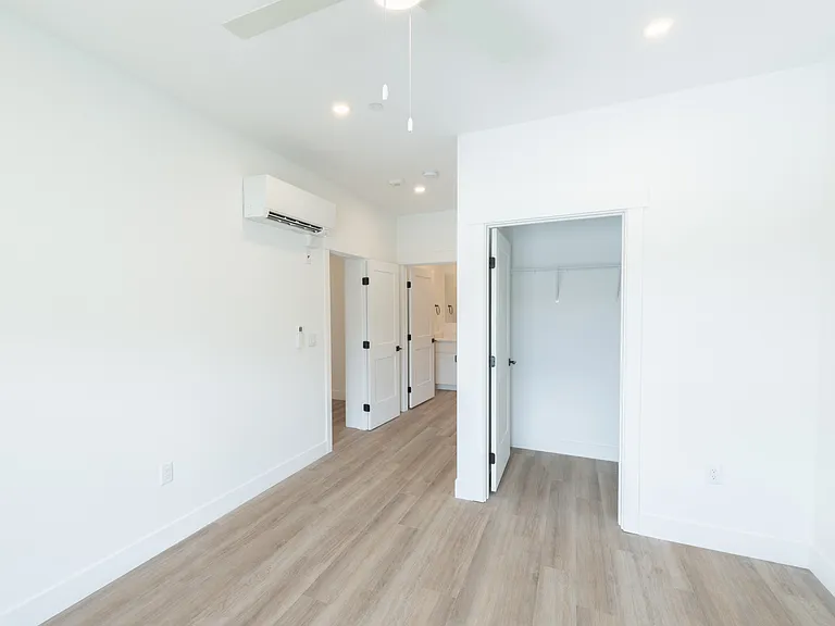 Primary bedroom with attached bath in 2-bed unit