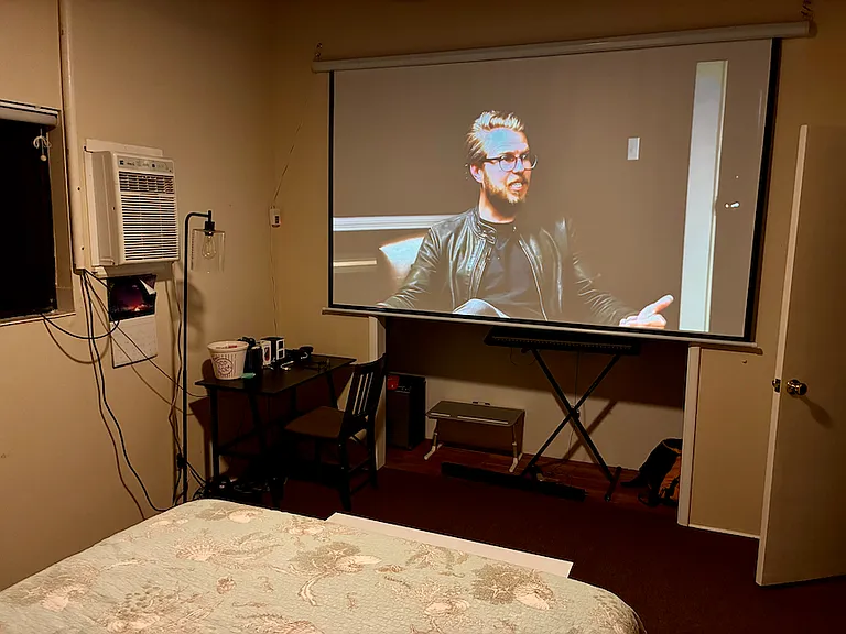 120 inch retractable projection screen large closet and storage behind the screen with Keyboard Amp and guitars