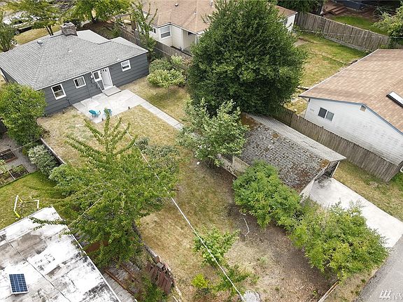 This aerial shot shows the large back yard with patio and garage